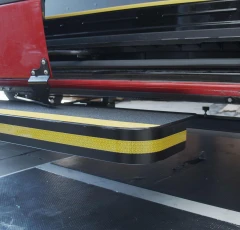 Level view of the UpStep retracted underneath the side of a van, showing off the mounting apparatus.